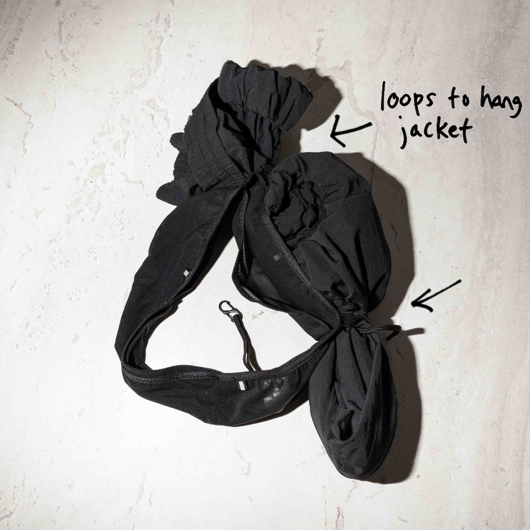 Top down image of Ninepine's running belt with a jacket attached onto the hanging loops